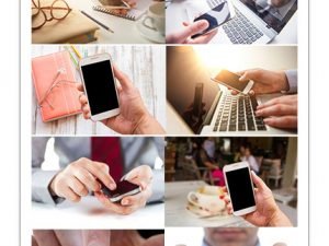 The Male Hand Holding A Phone Against The Background Of The Table